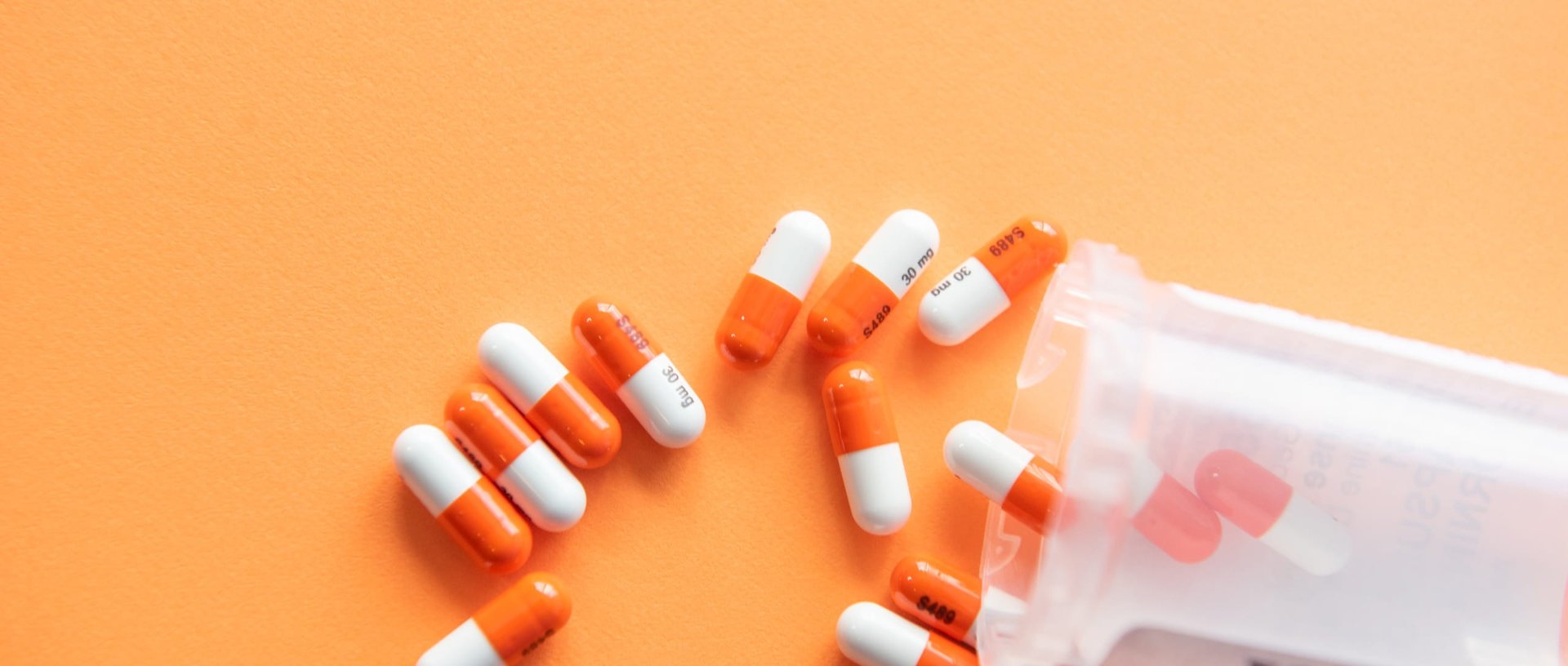 Pharma drugs and pills on a orange background