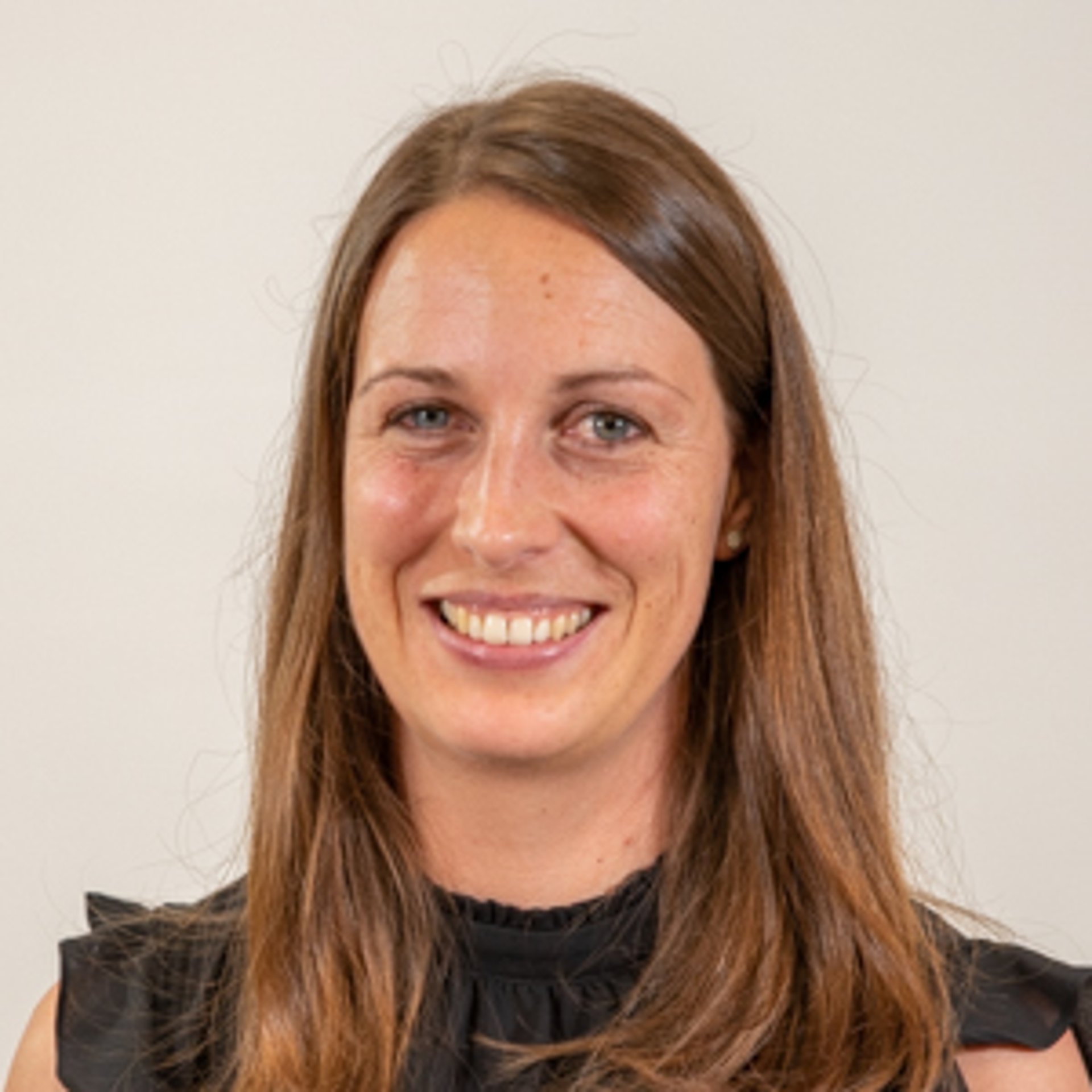 A smiling woman with long brown hair