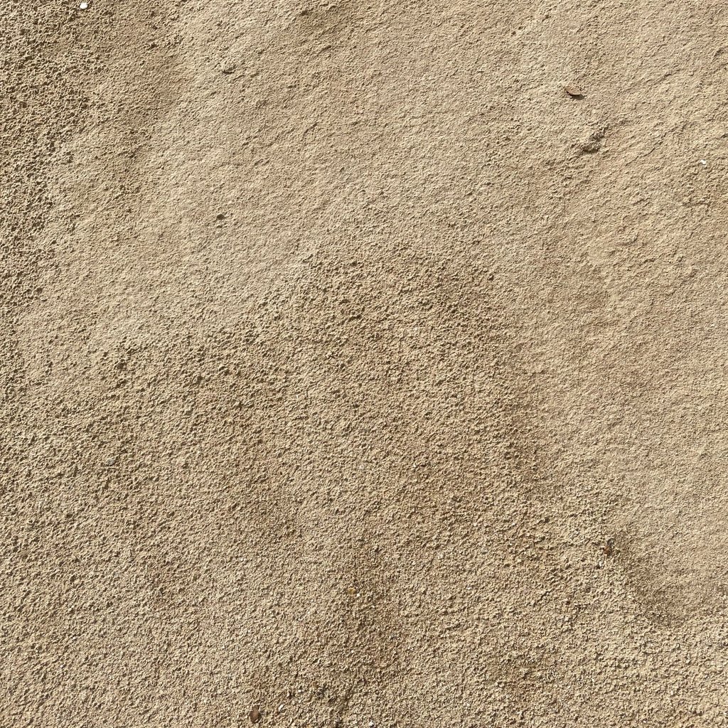 Overhead image showing the texture of play sand.