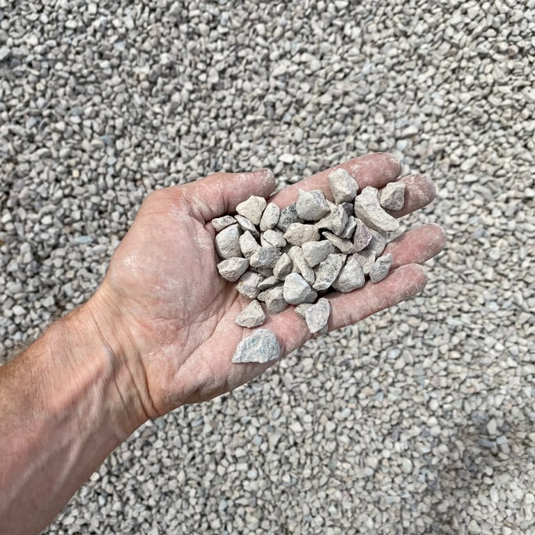 Overhead view of Missoula crushed river rock as it will look when it arrives, with a hand for scale reference.
