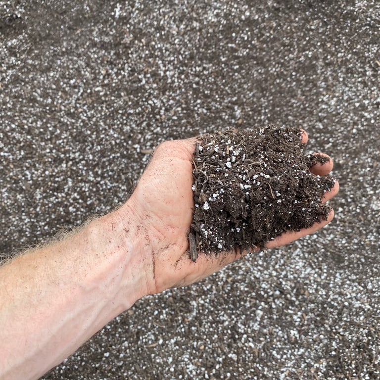 View of a Missoula Garden Soil texture, showing soil amendments with a hand for scale.