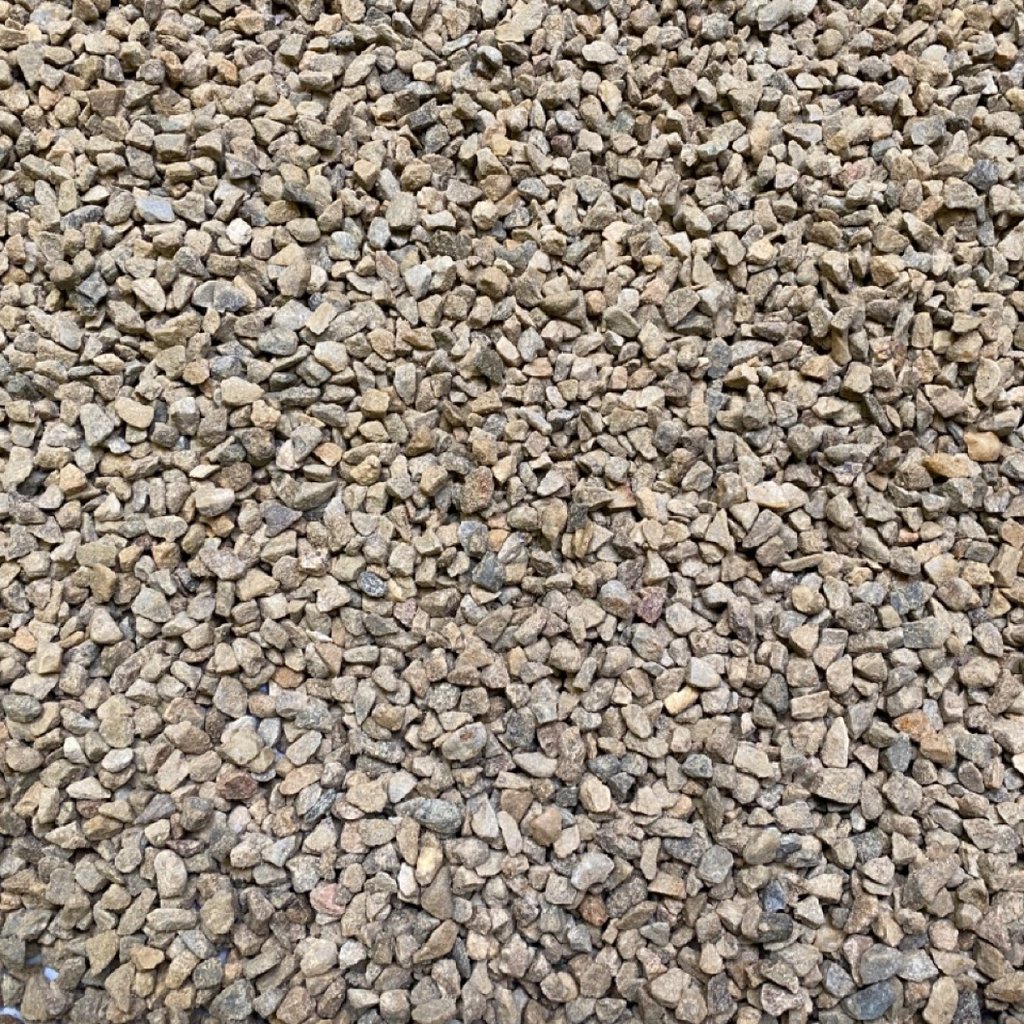 An overhead view of drainage gravel on a sunny day.