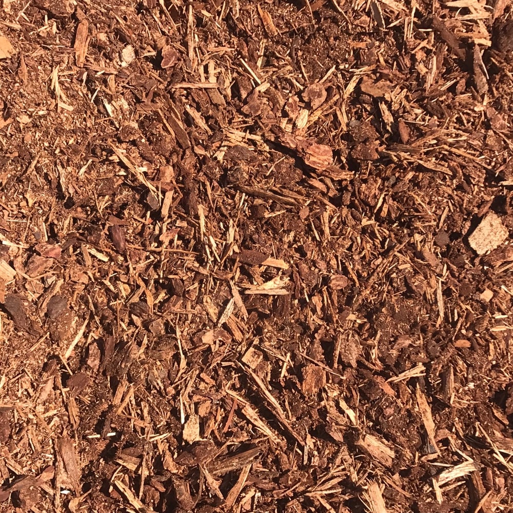 Overhead view of reddish shredded fir bark, a landscape material available for delivery from Little Dumps Missoula.