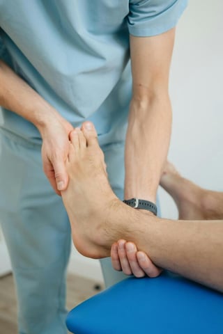 Podiatrist examining a patient's foot.