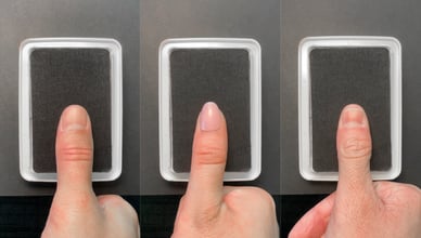 A composite image of close up thumbs pressing on a black ink pad