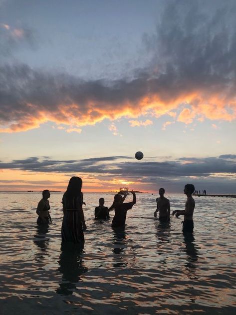 Family playing a ball game, enjoying outdoor activities together.