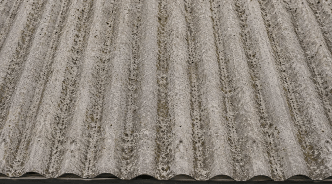 Weathered corrugated asbestos-cement roofing viewed close up