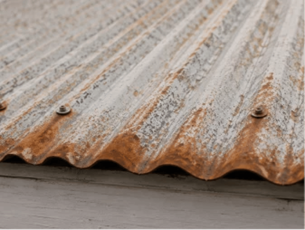Orange surface rust on a corrugated metal roof