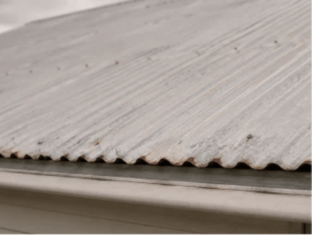 Chalking paint on a corrugated metal roof