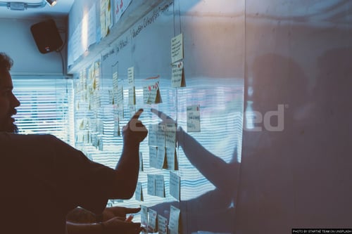 man looking at whiteboard