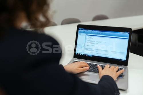 woman typing email on a laptop