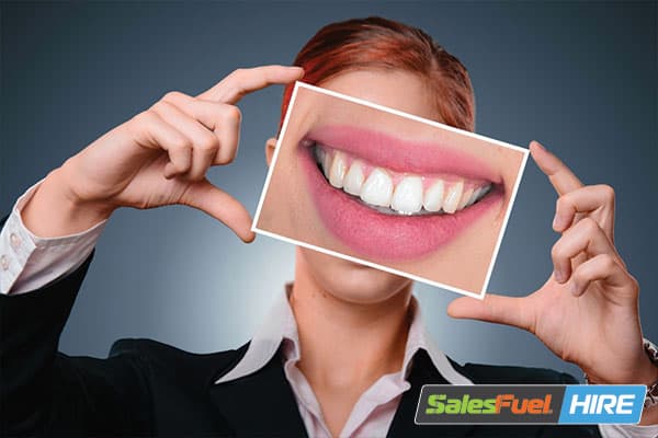 Girl holding a frame with a smiling face