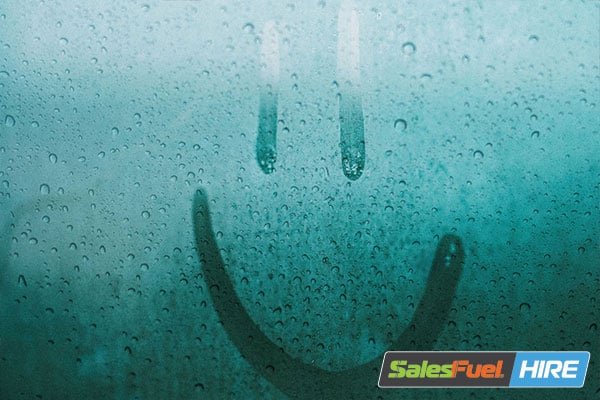 Smiley face drawn on a fogged glass window