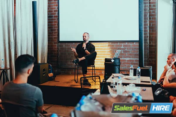 Smiling salesperson talking confidently.