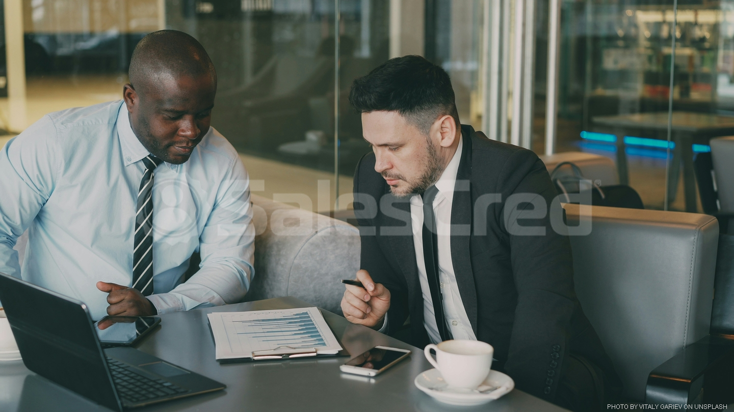 two men sitting at table