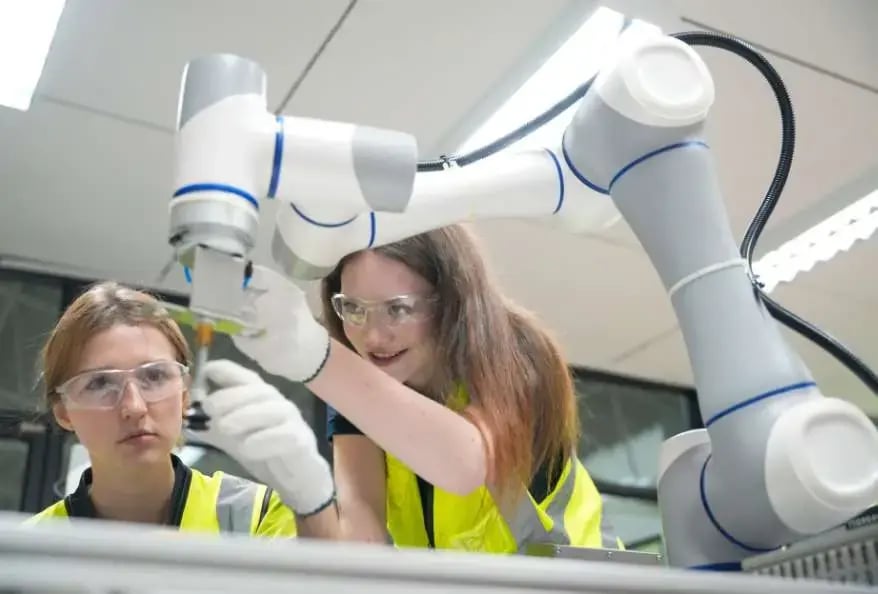 students engage with collaborative robot in modern education.