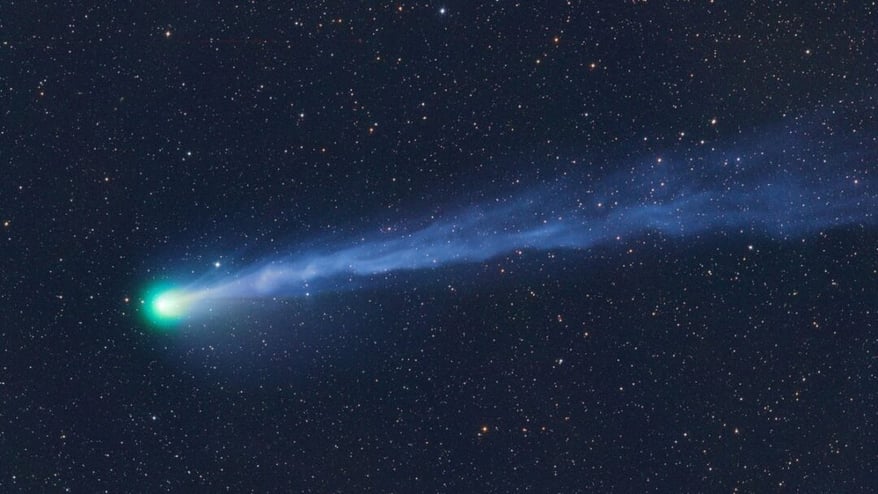 The Explosive Green Comet Racing Towards Earth and Andromeda Galaxy