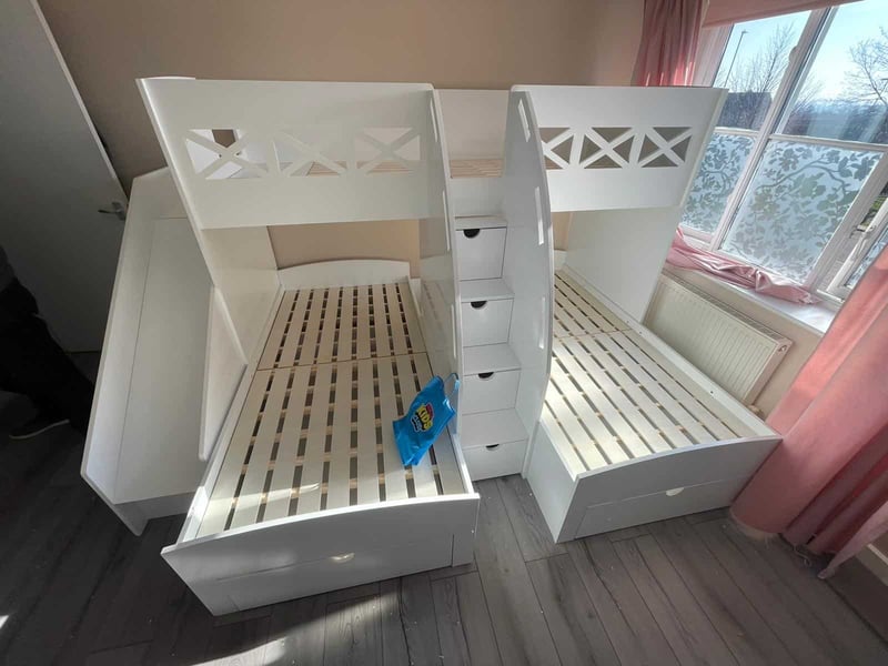 Wooden corner bunk beds with stairs and storage