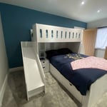 L-shaped double bed and single bed bunk with integrated shelves