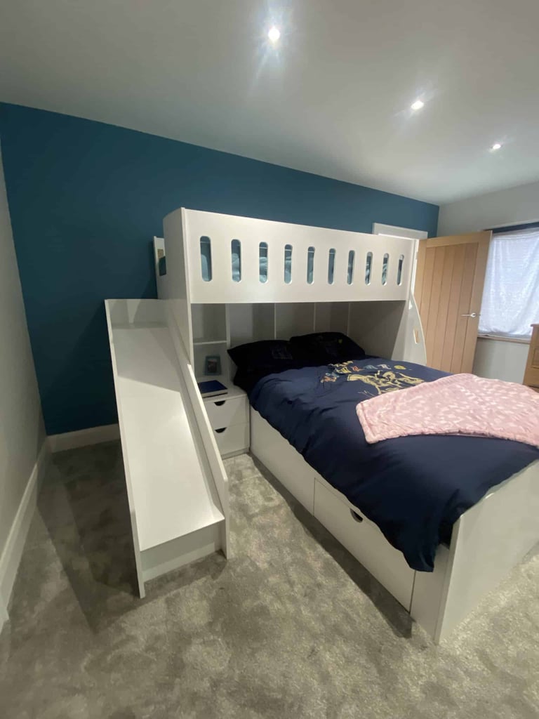L-shaped double bed and single bed bunk with integrated shelves