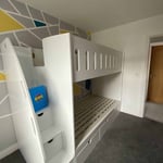 Single wooden bunk beds with stairs