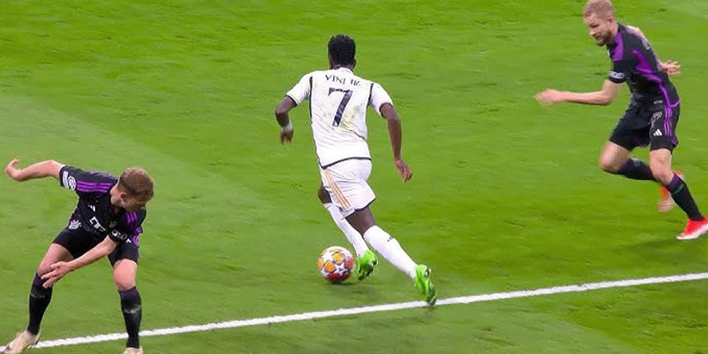 Vinicius Junior dribbling past two Bayern Munich players