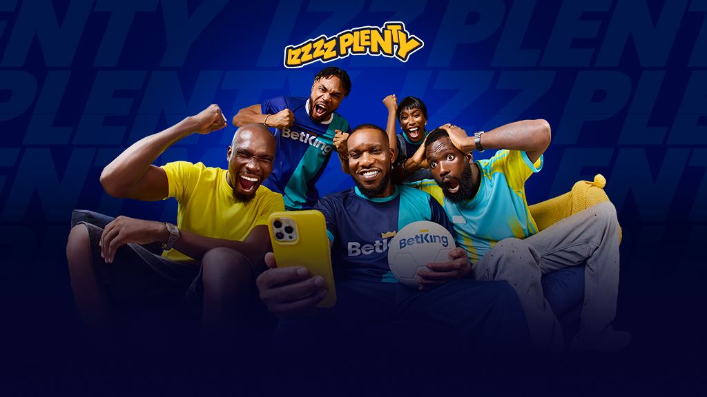 BetKing's "Early Millionaires" blog graphic - JayJay Okocha sitting between four male models, holding a ball and exclaiming at the phone