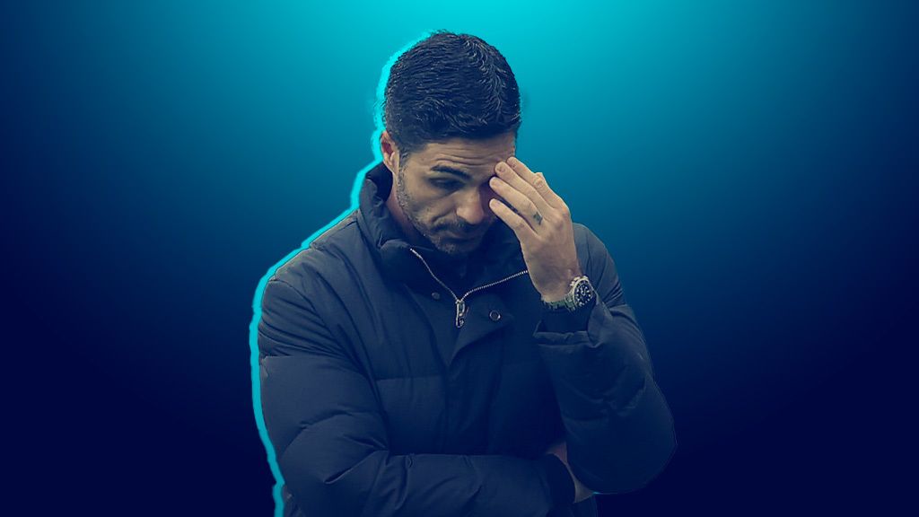 Arsenal manager Mikel Arteta with his head in his hand looking frustrated on the touchline
