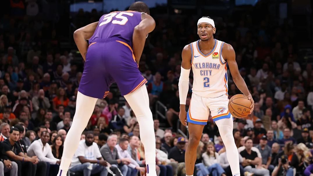 Shai Gilgeous Alexander facing up to Kevin Durant, who's in a defensive stance