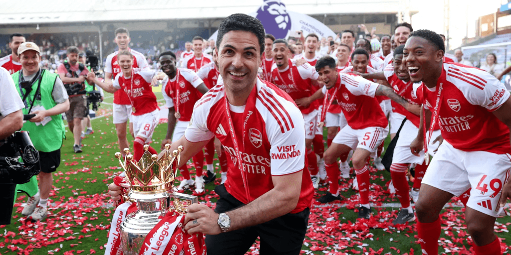 Mikel Arteta hoisting the EPL trophy with Arsenal players in the background