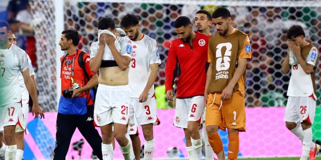 Tunisia players trudging off the pitch after a horrible World Cup performance .jpg