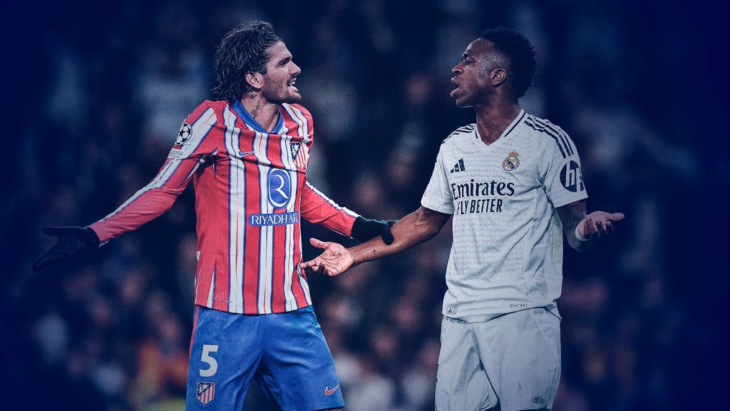 Rodrigo de Paul and Vinicius Junior exchanging words with their arms spread wide