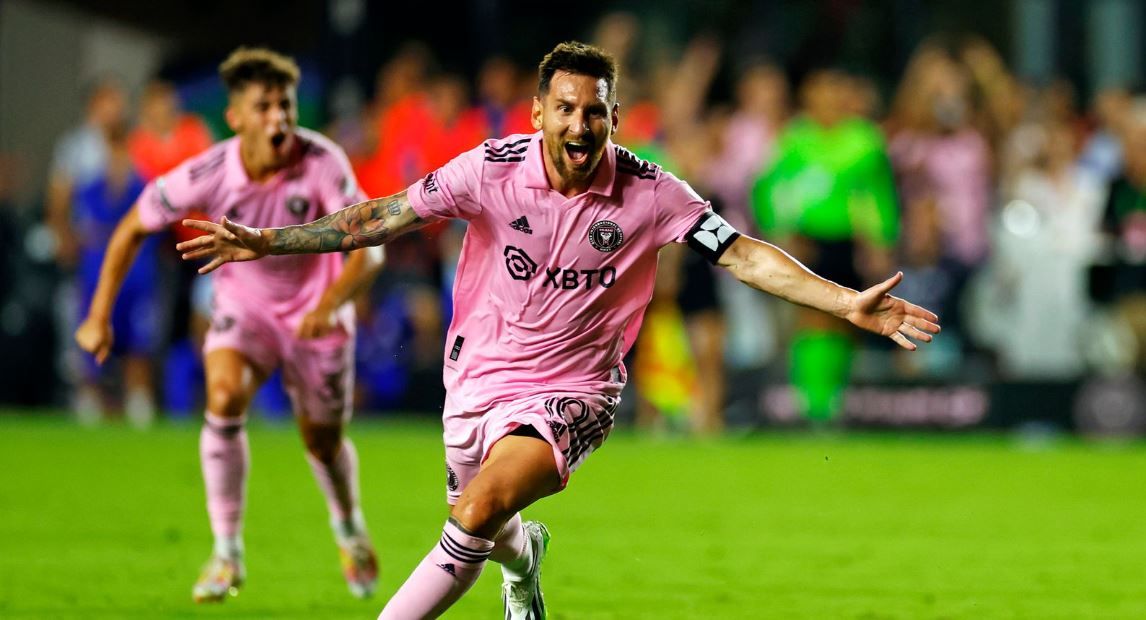 Lionel Messi celebrating a goal with his teammate in the background