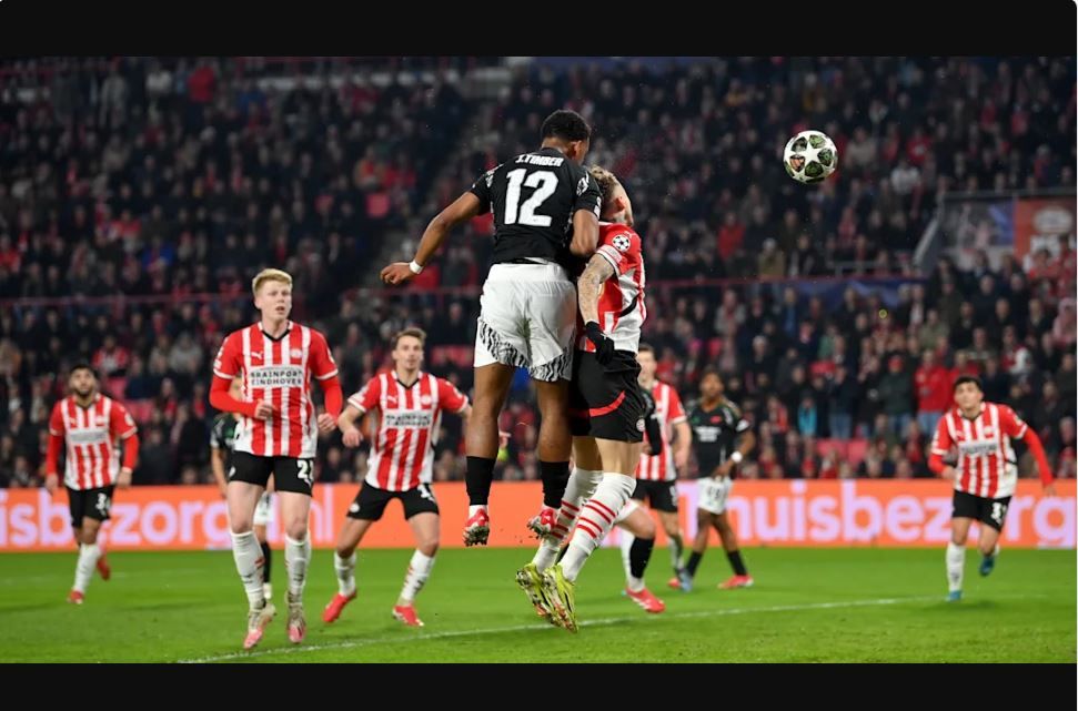 Jurrien Timber jumping to head the ball