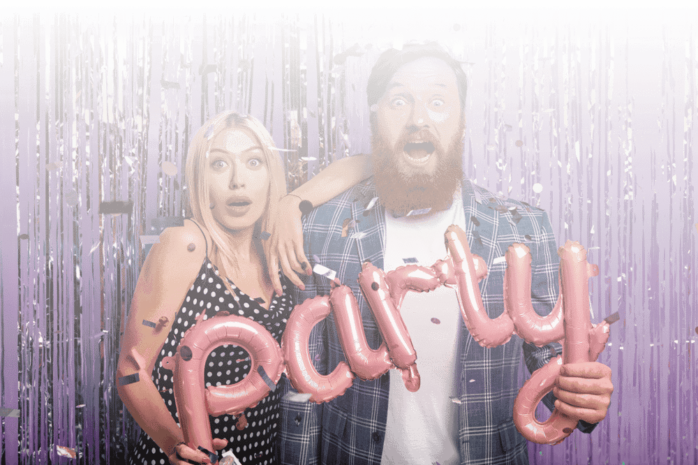 Guests celebrating at a wedding party with confetti, perfect for a wedding guest book and QR code to collect photos.