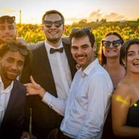 Group of friends at a wedding reception. Perfect for your wedding guest book to collect wedding photos with QR code.