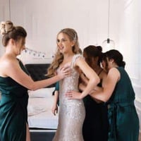 Bride getting ready with bridesmaids, perfect moment for wedding guest book photos. Use QR code to collect memories.