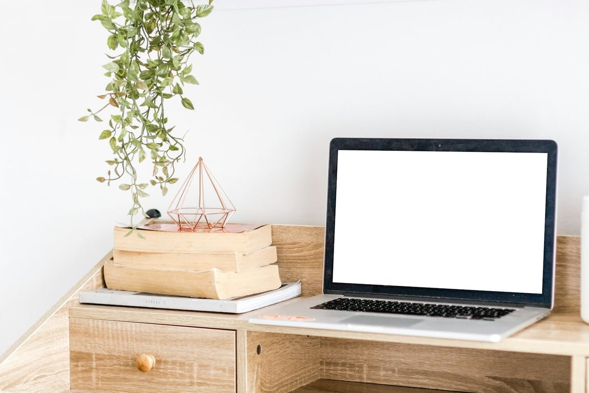 Silver MacBook on a wooden desk