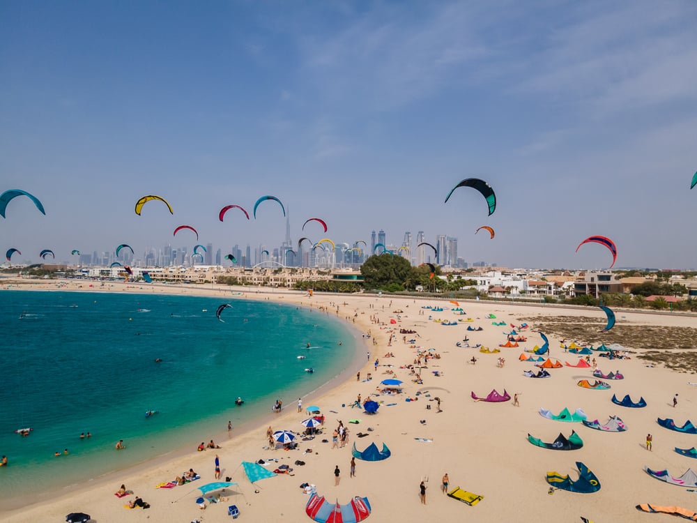 An aerial shot of Kite Beach in Dubai filled with kite surfers