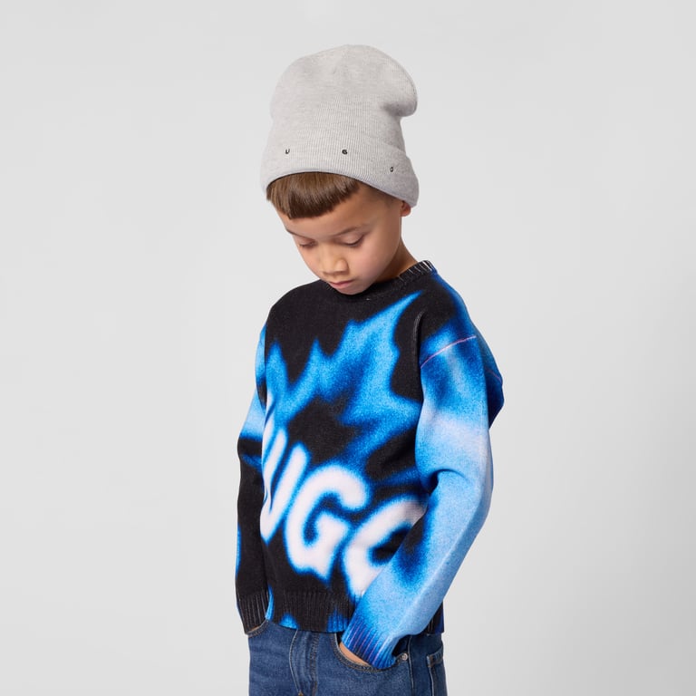 Cream cable-knit cardigan on a young boy