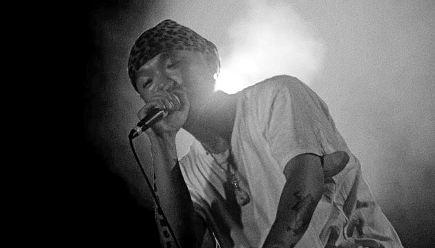 Hip hop artist Bohan Phoenix performing backlit