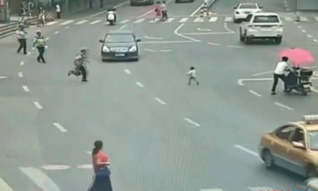 Feature image of Watch: Traffic Cop Dashes Across Street in Guizhou, China to Save Toddler