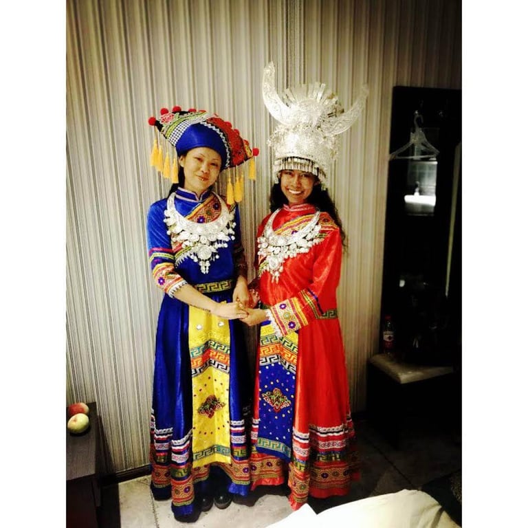 ChaCha and Kayla in traditional Baizu garb in Guizhou.