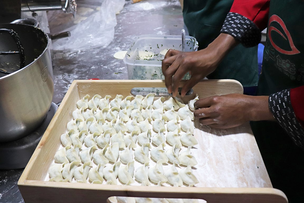 Jasper Dumplings staff folding dumplings