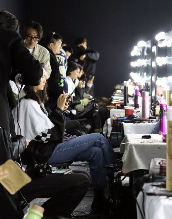 Models wait in line and stylists check their looks. Image by Wang Junjie
