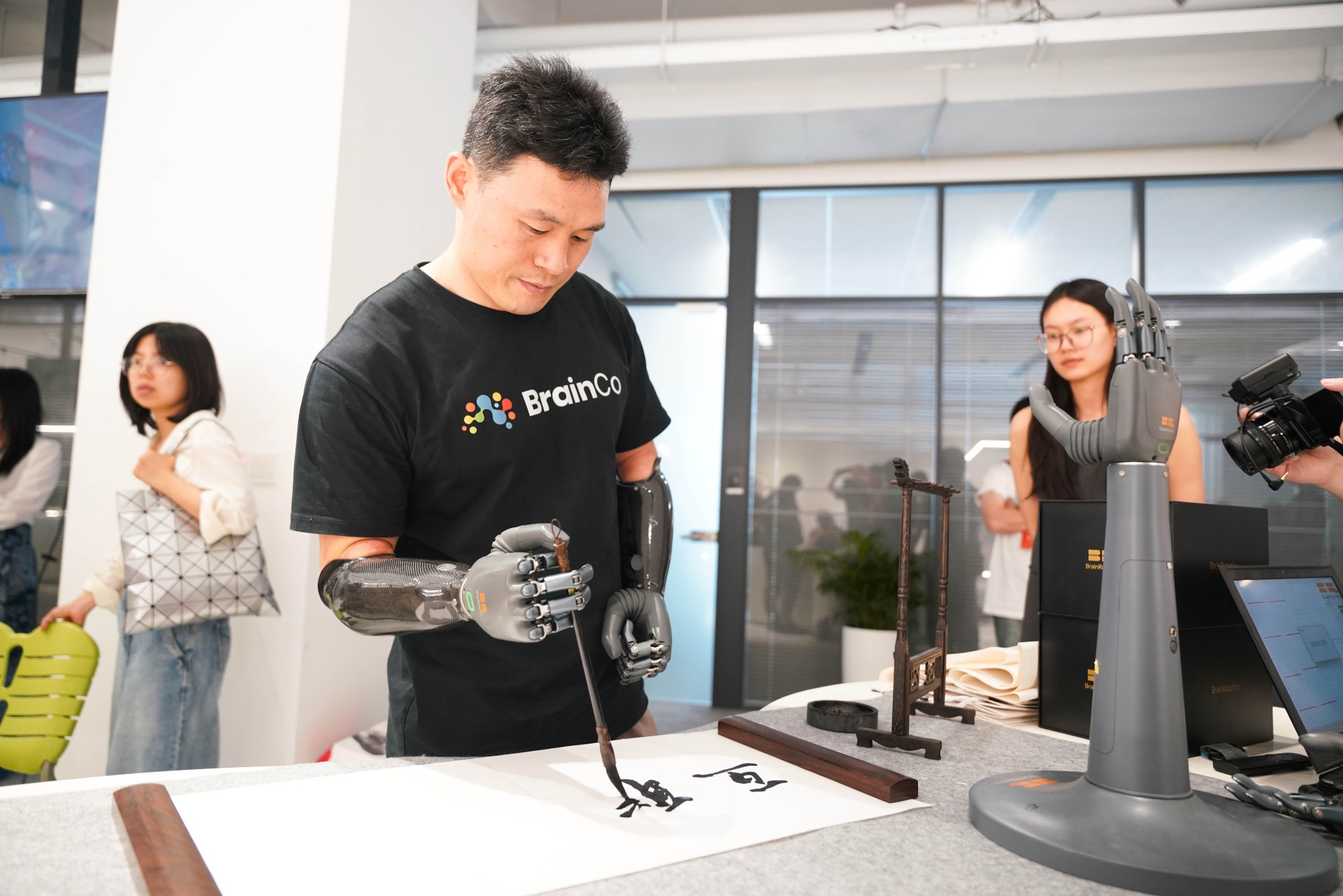 Feature image of BrainCo Unveils Brain-Controlled Bionic Hand That Lets You do Calligraphy