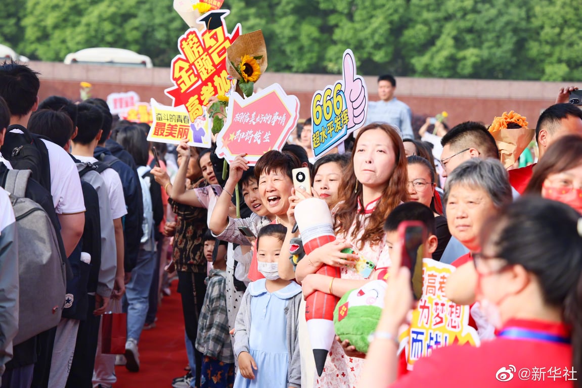 Families of the 2023 gaokao takers cheer them on outside the test venue.