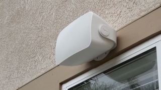 Un difuzor personalizat Sonos montat pe un perete exterior deasupra unei ferestre.