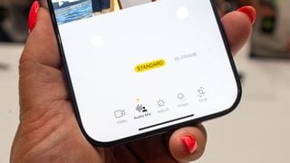 iPhone 16 Plus smartphone ținut în mână, prim-plan al părții de jos a ecranului