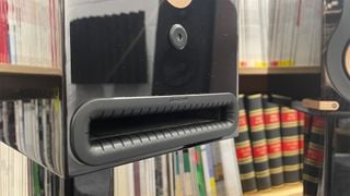 Boxele Monitor Audio Studio 89 pe suport, arătând portul bass reflex